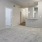 Spacious and well lit living room with wood floors and an open floor plan with access to the kitchen.