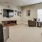 Spacious and well lit living room with wood floors and an open floor plan with access to the kitchen.