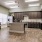 Spacious and well lit kitchen with wood floors and stainless steel appliances. 